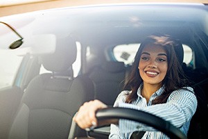 Woman smiling while driving home