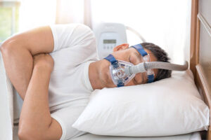 Sleeping man wearing a CPAP